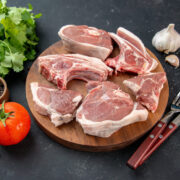 front-view-fresh-meat-slices-raw-meat-with-greens-tomatoes-dark-background-kitchen-meal-food-cow-food-dish-salad-barbecue-animal